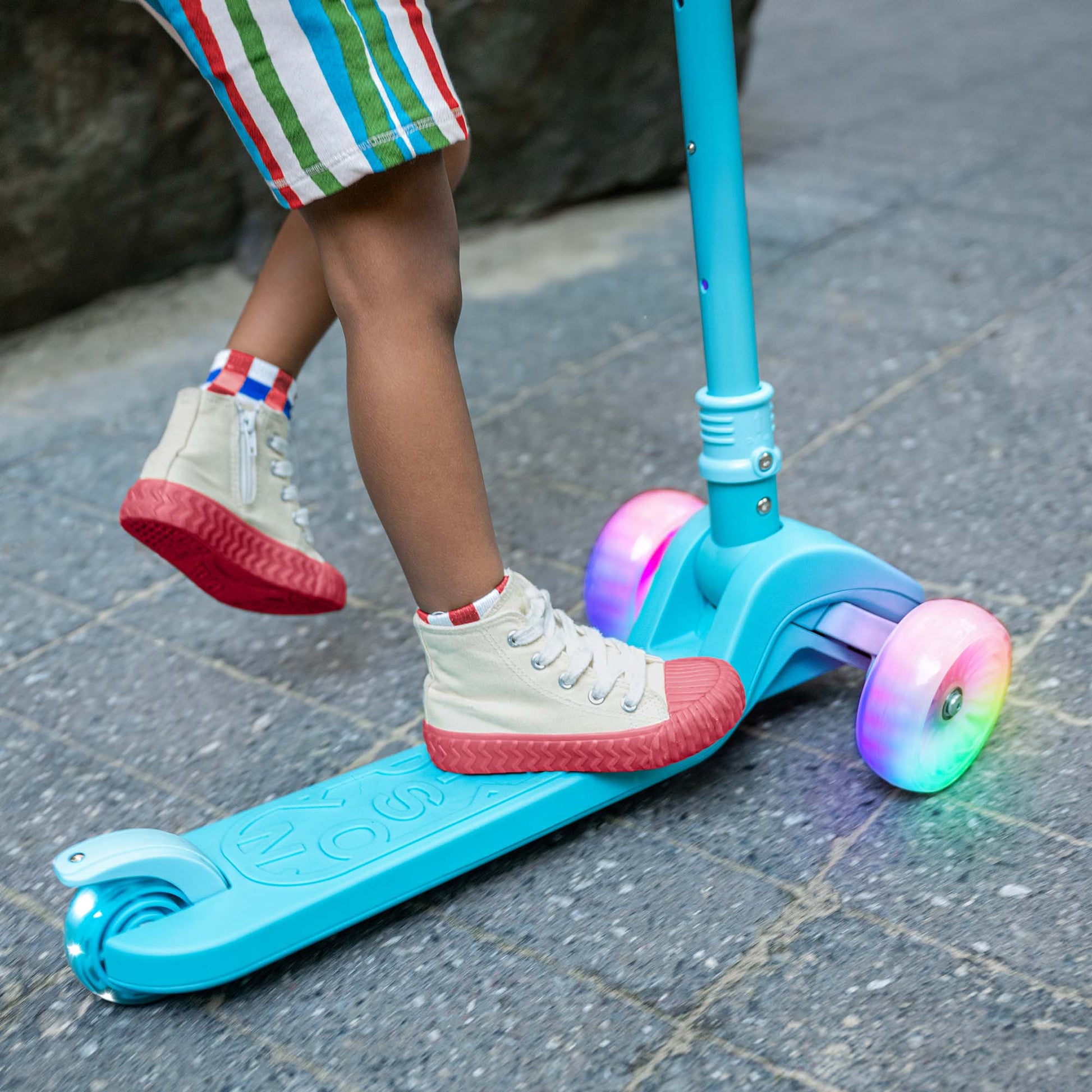 kid standing on blue bloom kick scooter