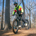 man riding core e-bike through the woods