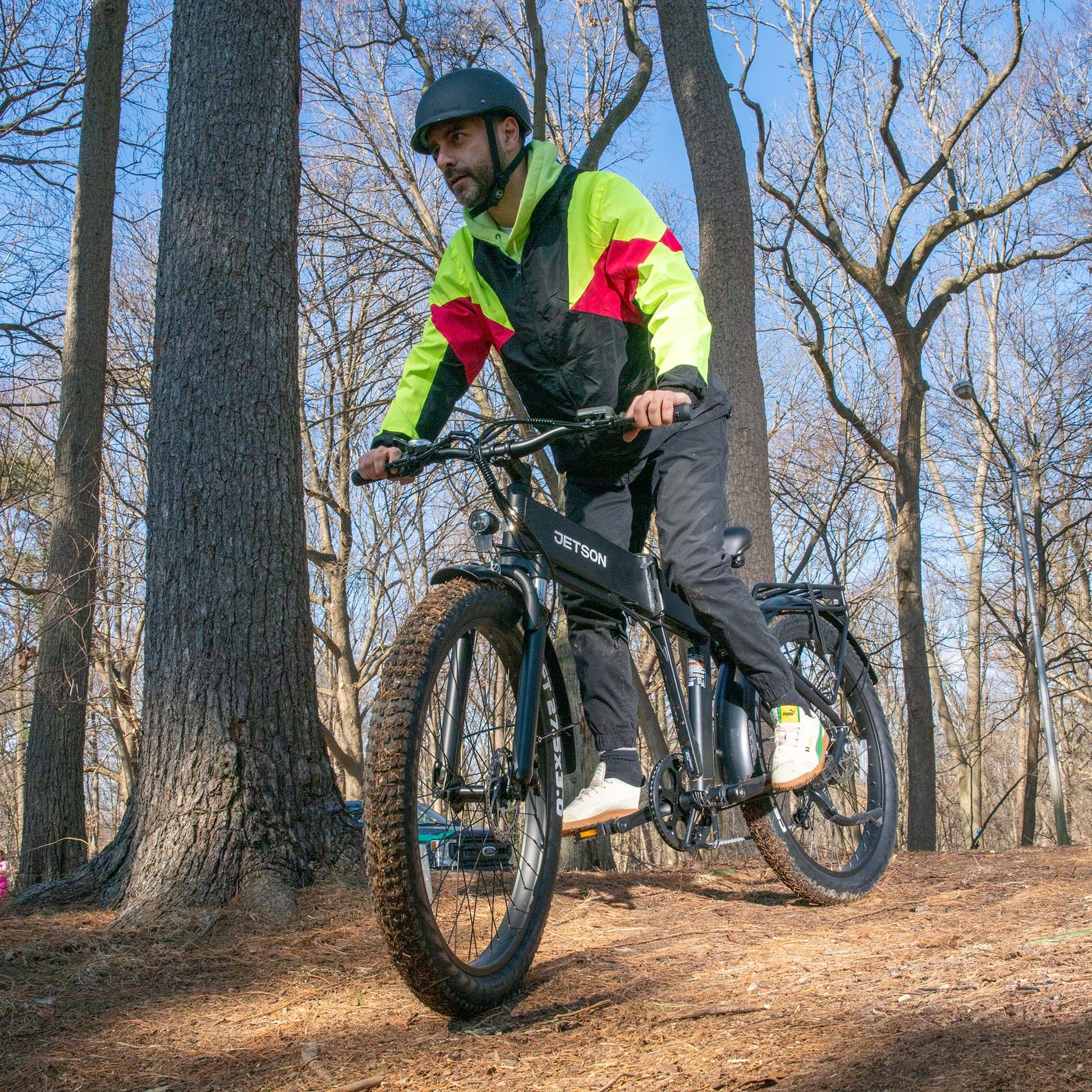 man riding core e-bike through the woods