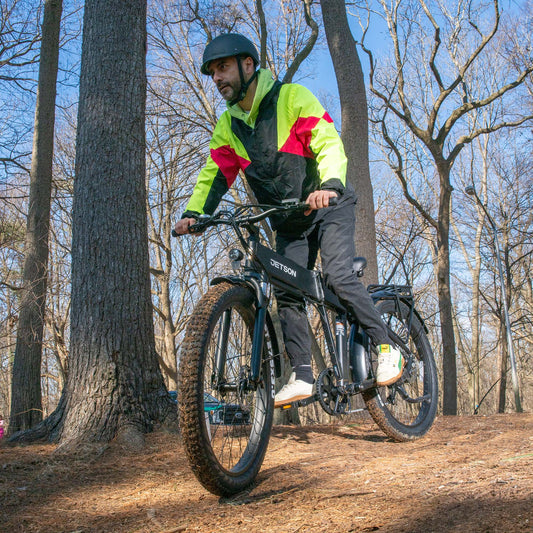 man riding core e-bike through the woods