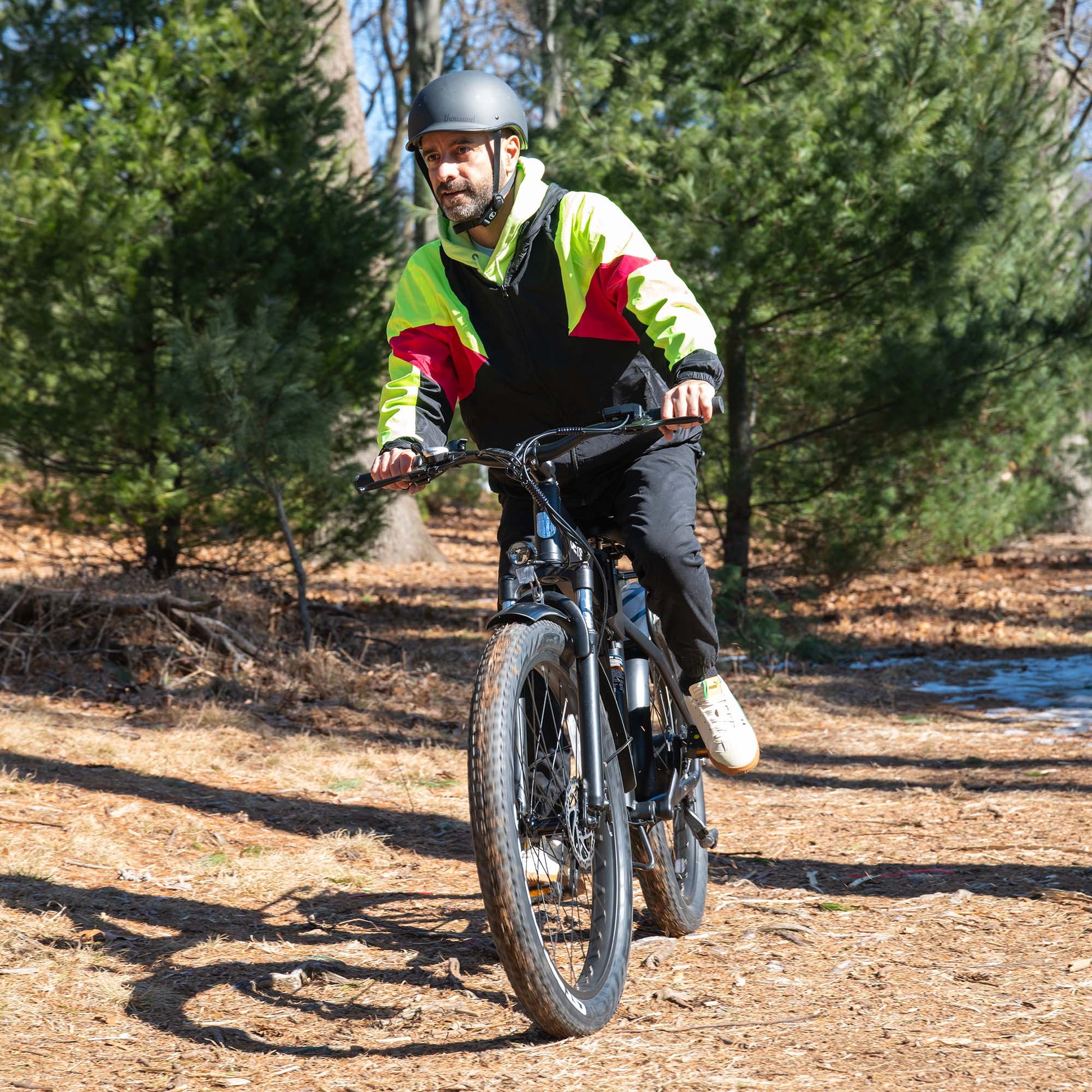 man riding core e-bike through the woods