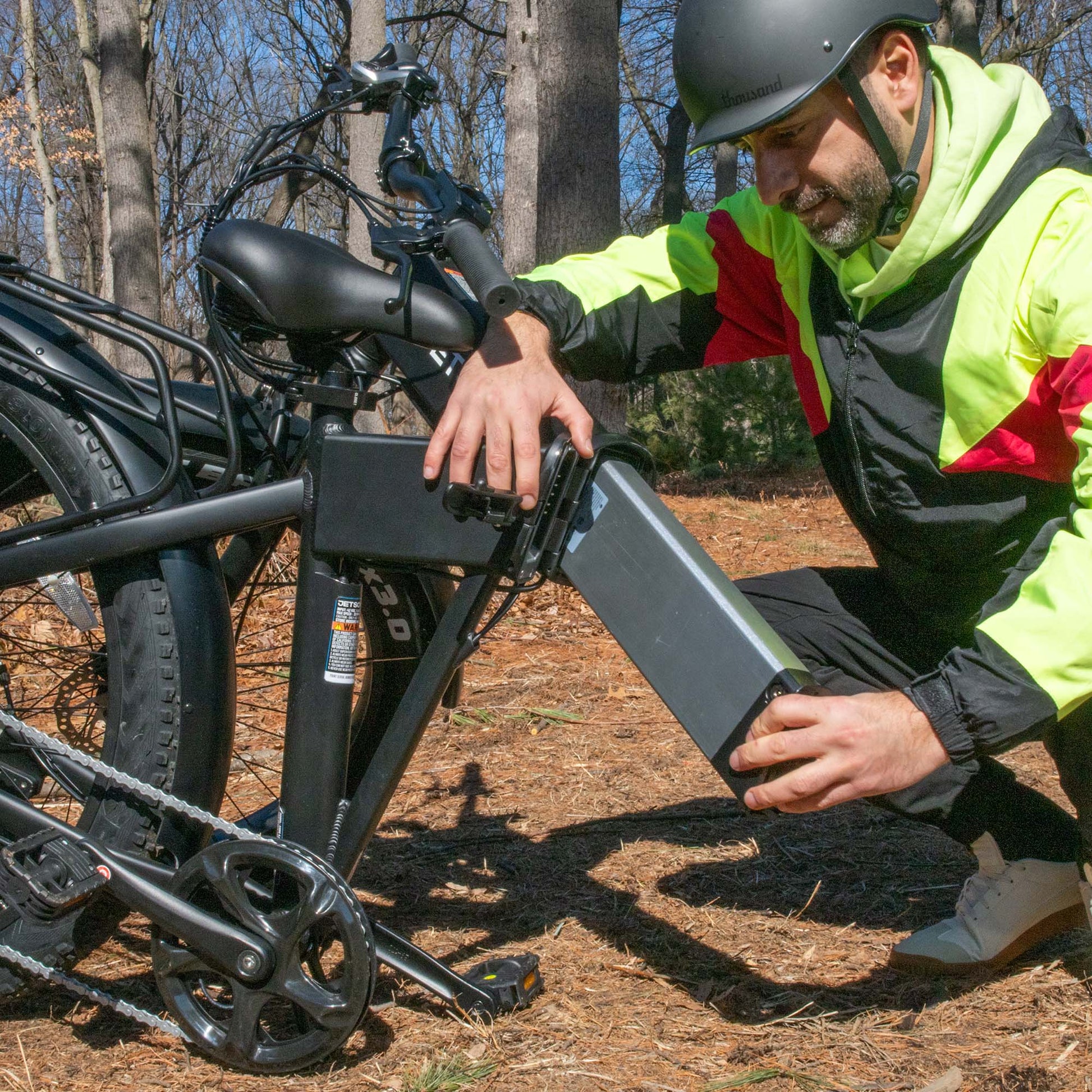 man removing battery from core e-bike