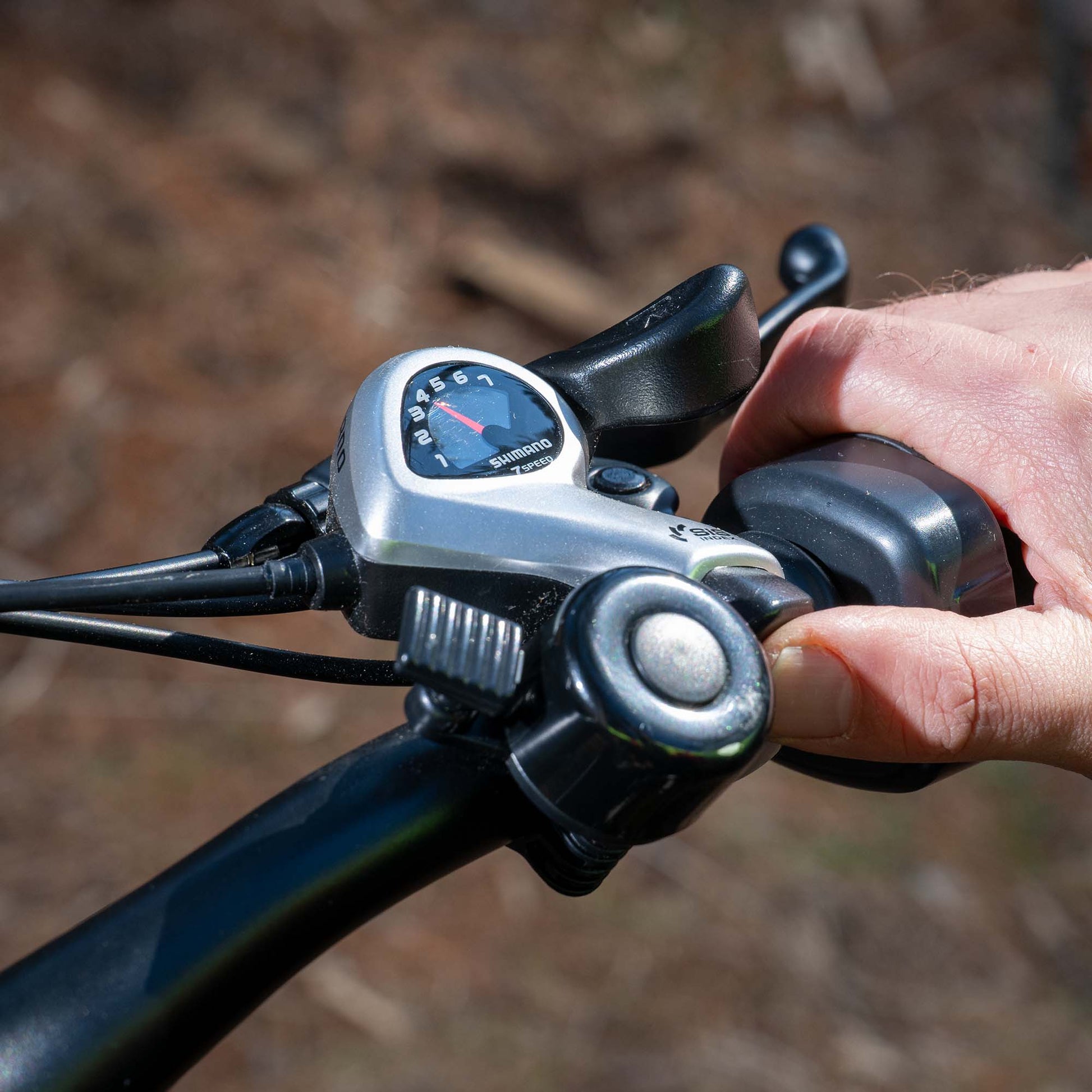 close up of gear gauge and bell on core e-bike handlebar