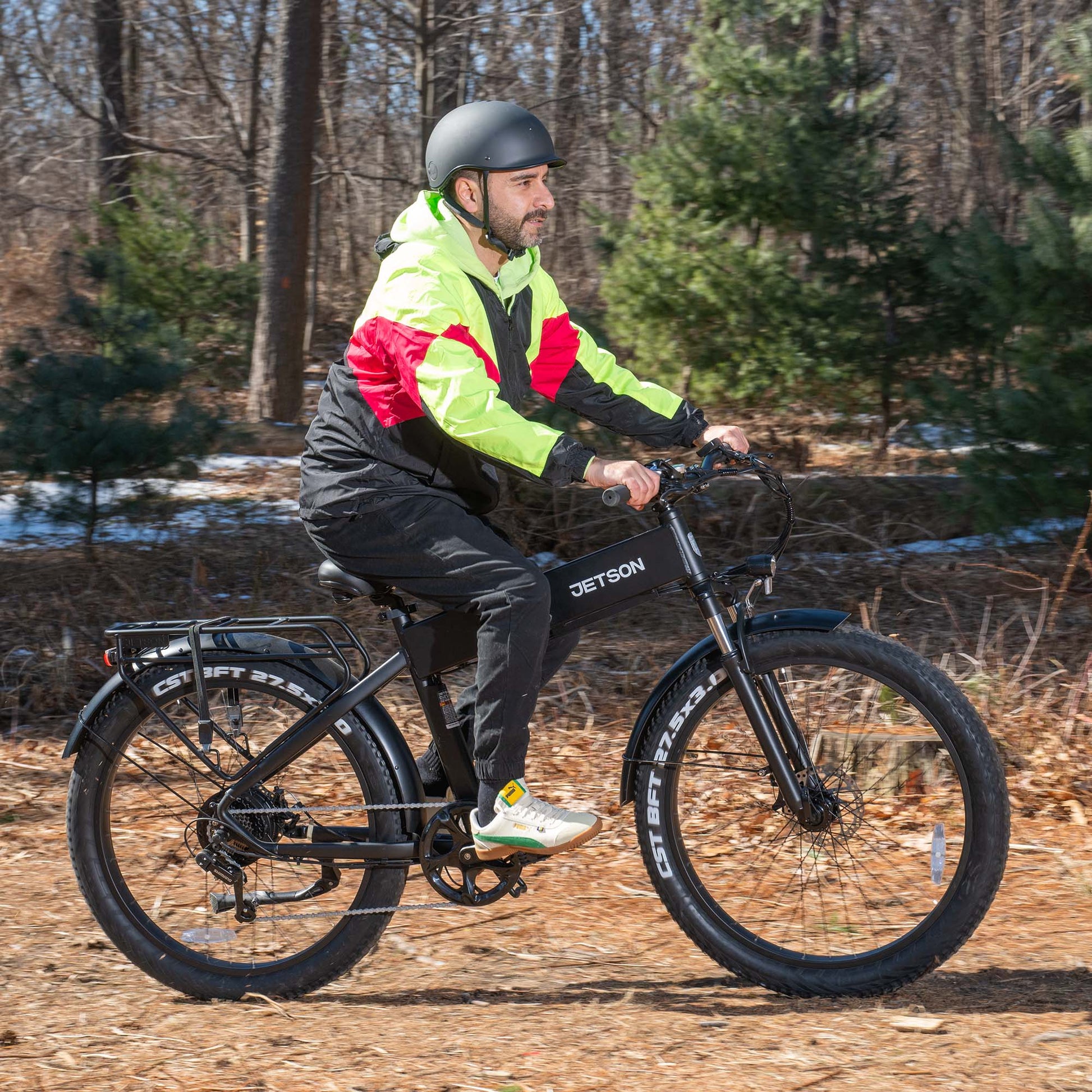 man riding core e-bike through the woods