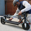 person folding eris pro electric scooter in half