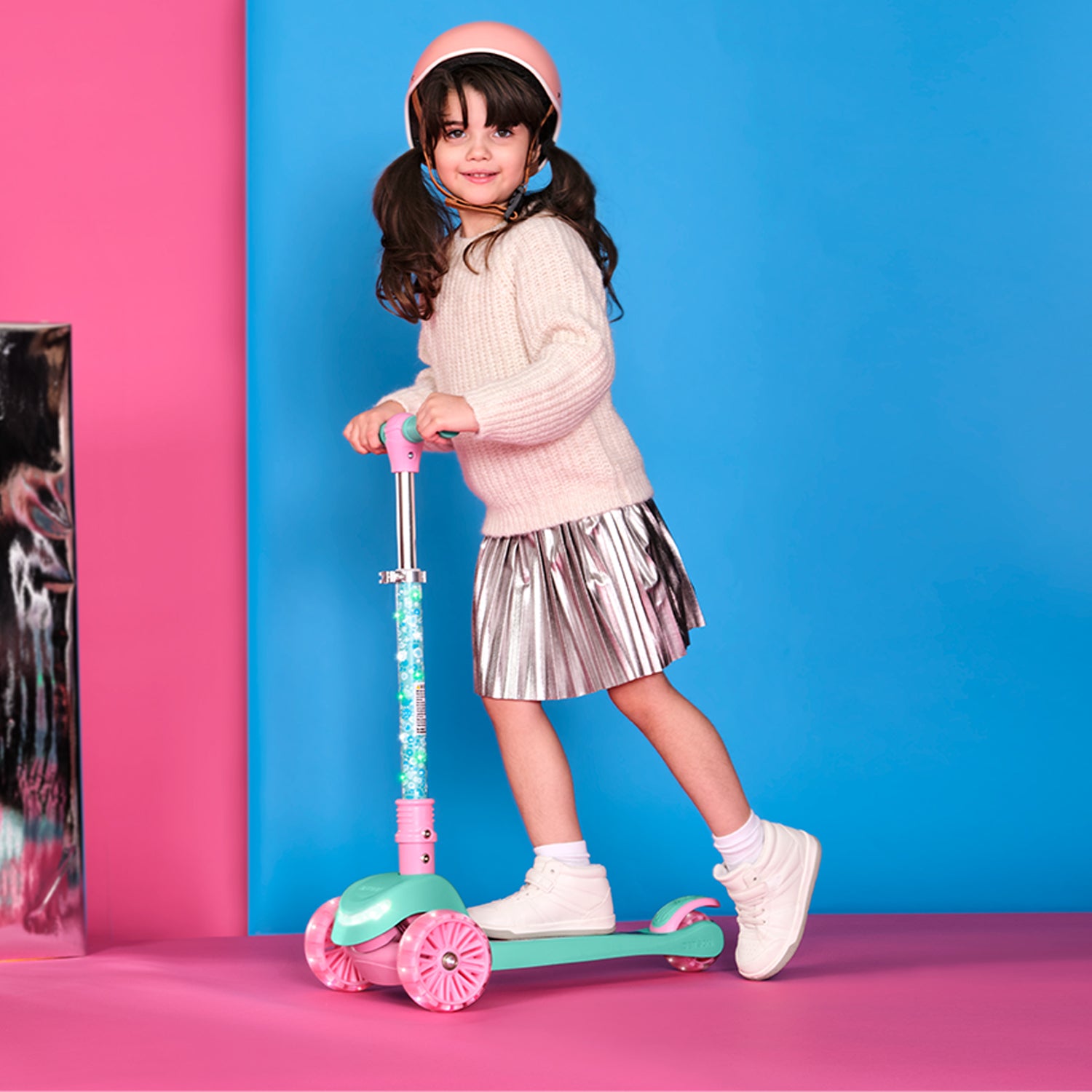 young girl riding gabby's dollhouse kick scooter