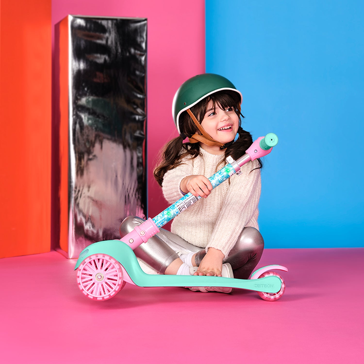 young girl folding gabby's dollhouse kick scooter in half