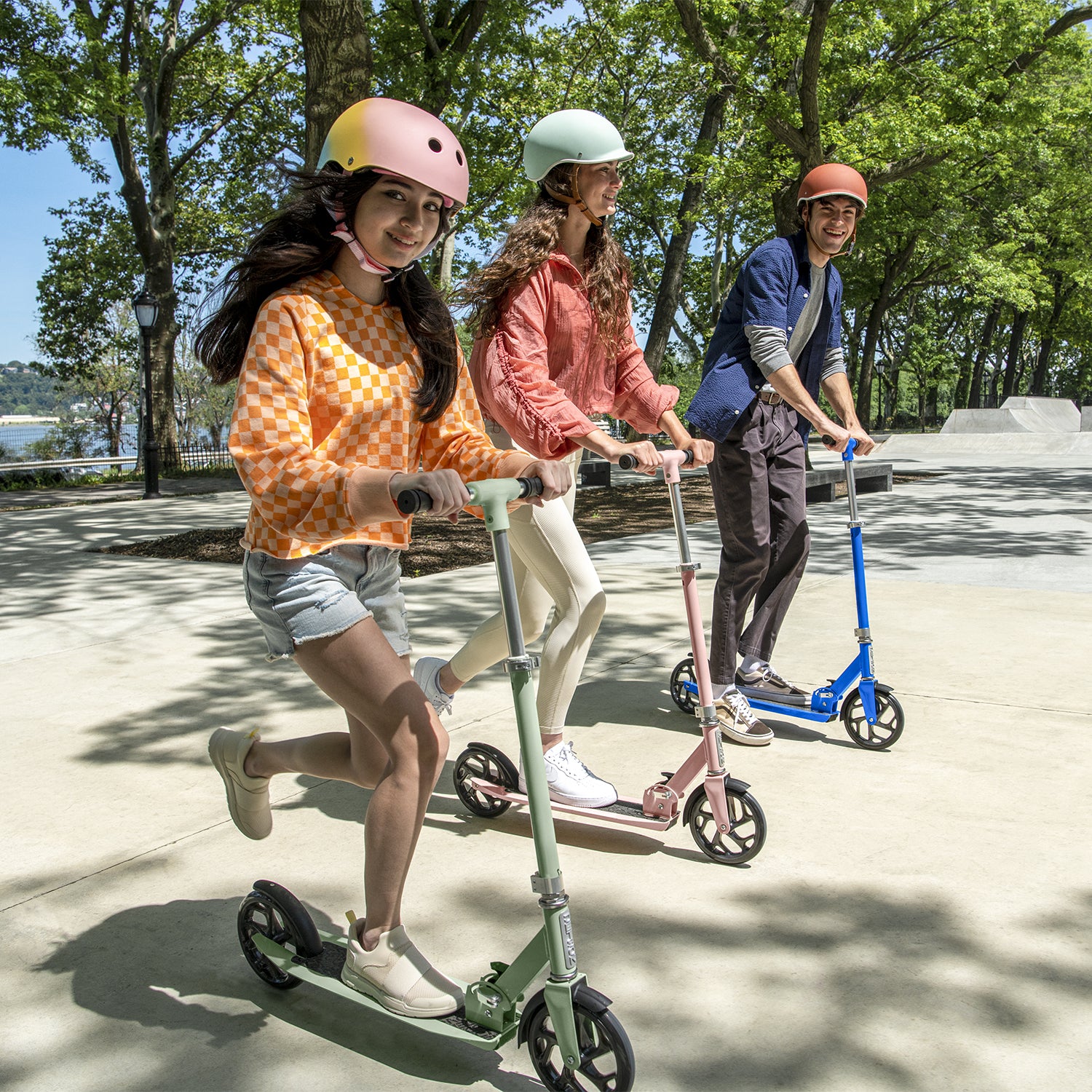 three kids riding hex kick scooters