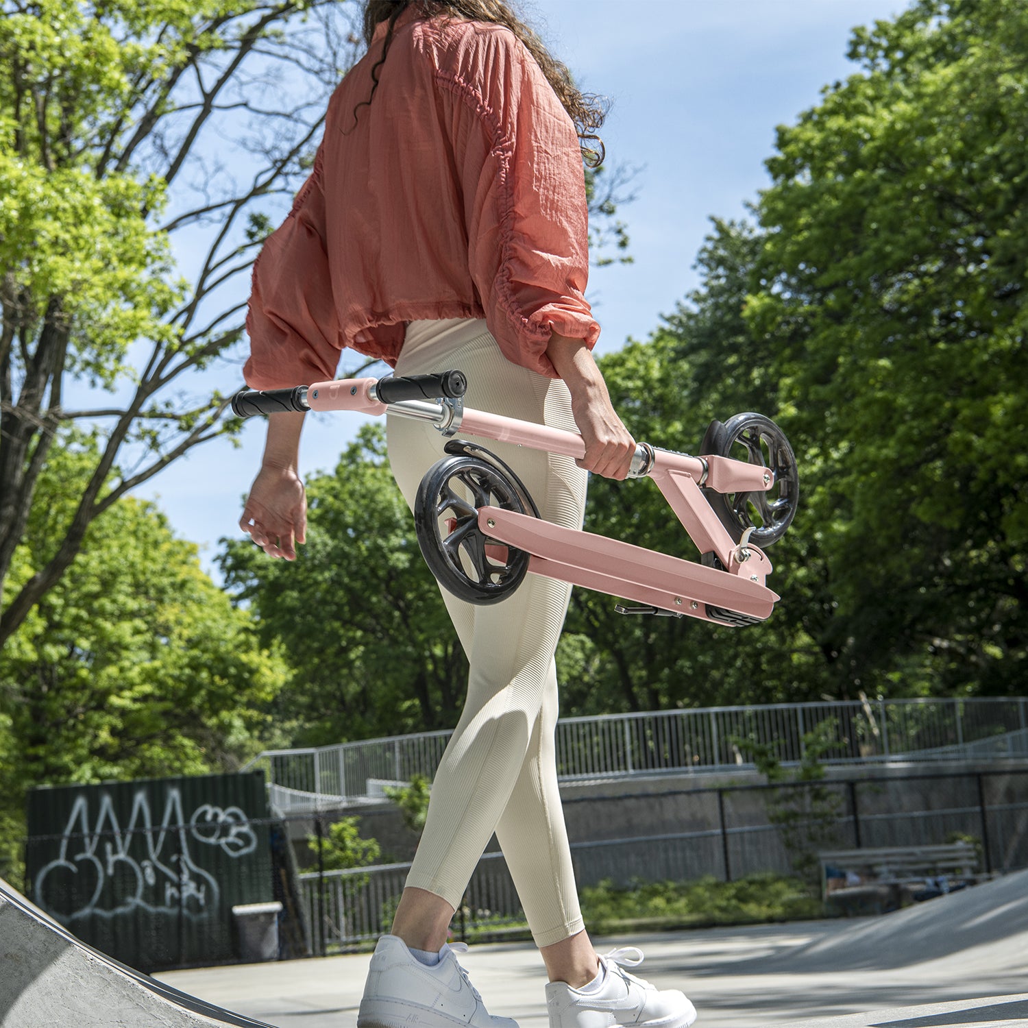 kid carrying folded rose gold hex kick scooter