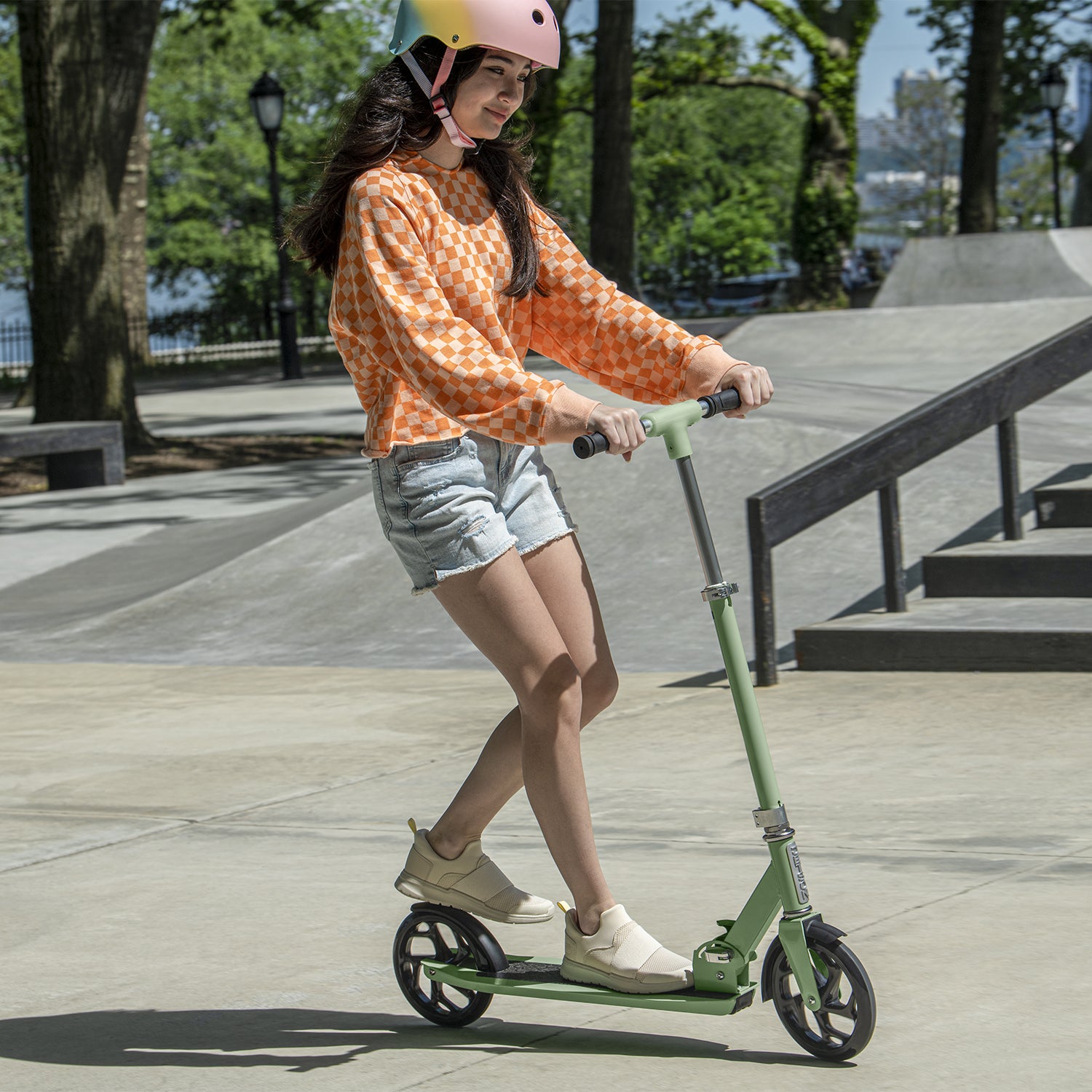 kid riding sage green hex kick scooter
