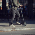 close up of person on the knight scooter on the sidewalk
