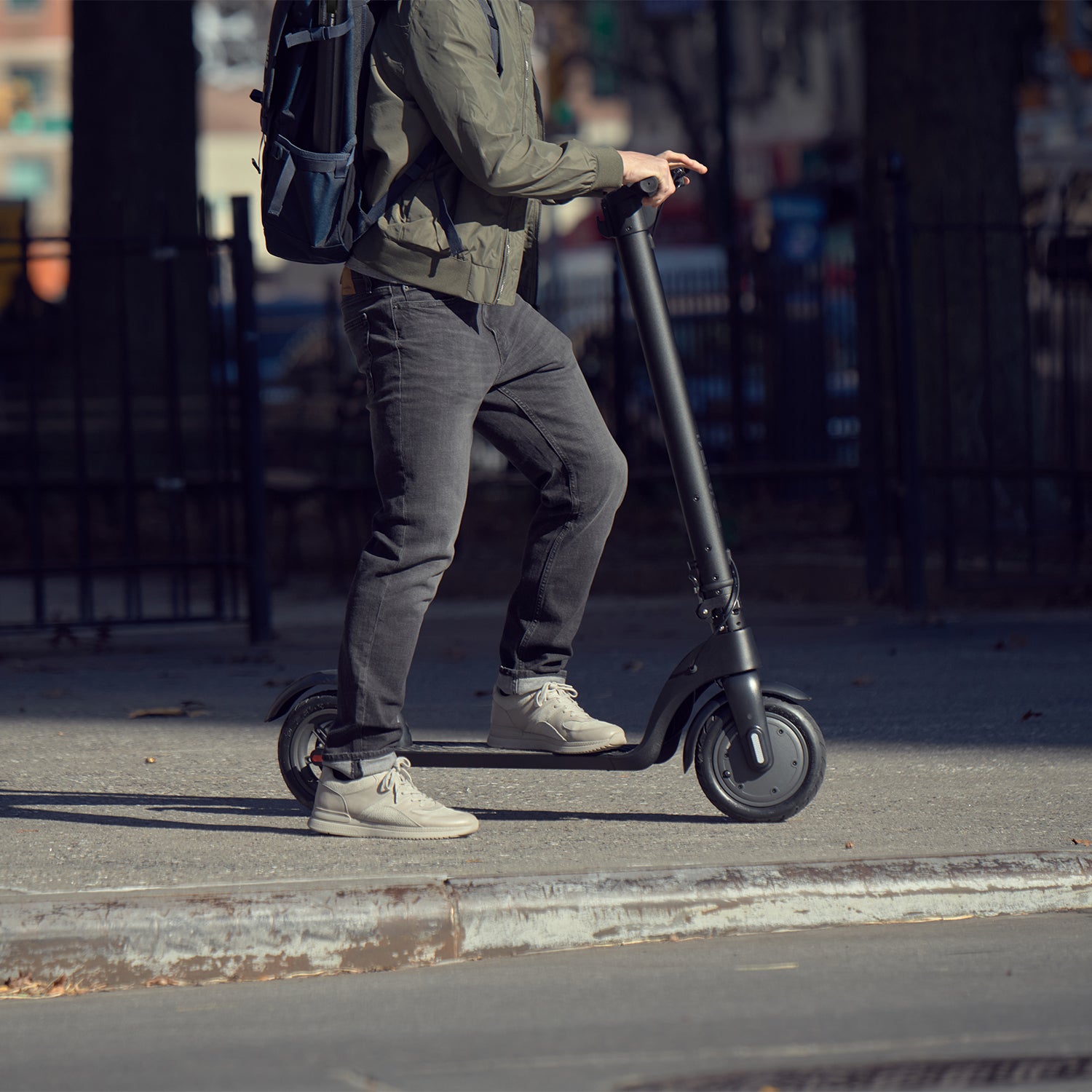 close up of person on the knight scooter on the sidewalk