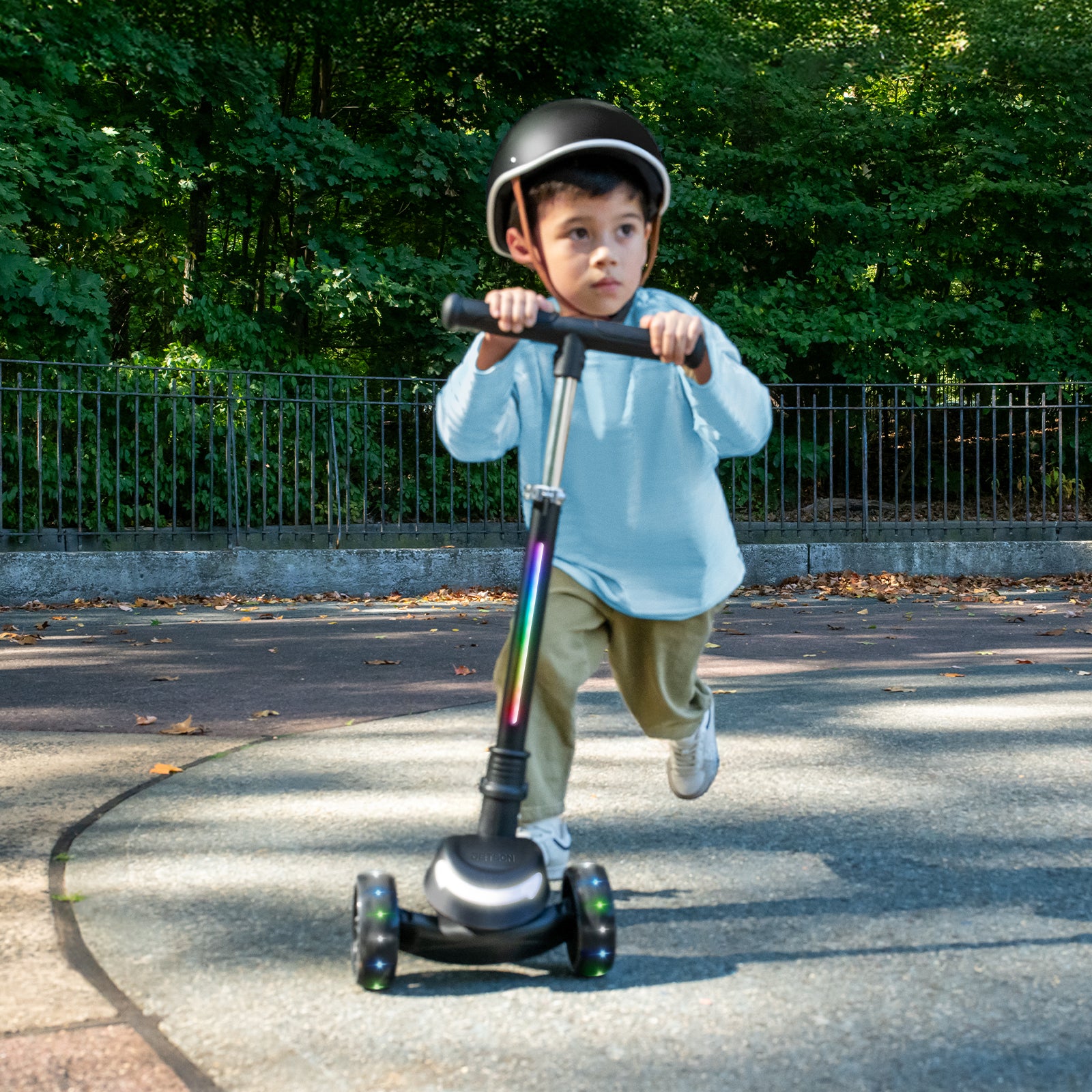 little kid riding black leap kick scooter