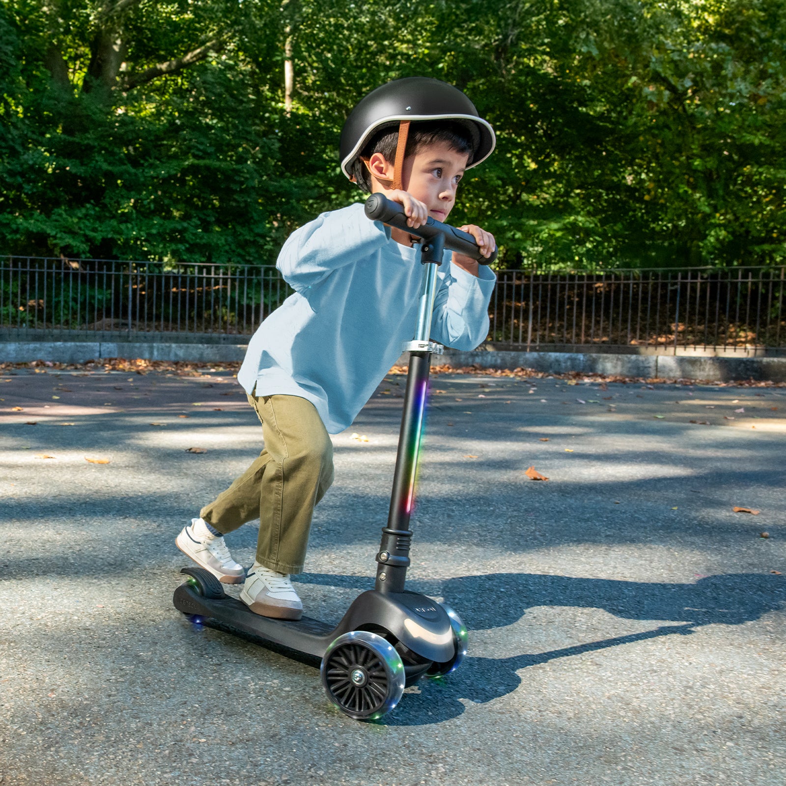 little kid riding black leap kick scooter