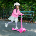little kid riding pink leap kick scooter in park