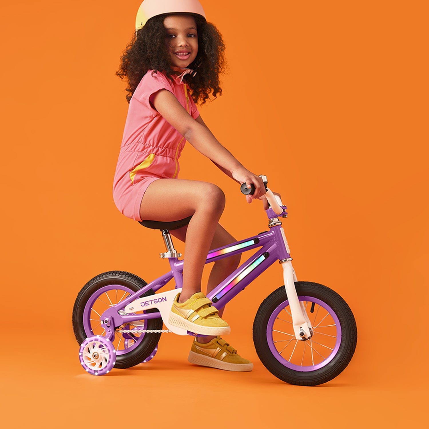 young kid riding purple light up bike
