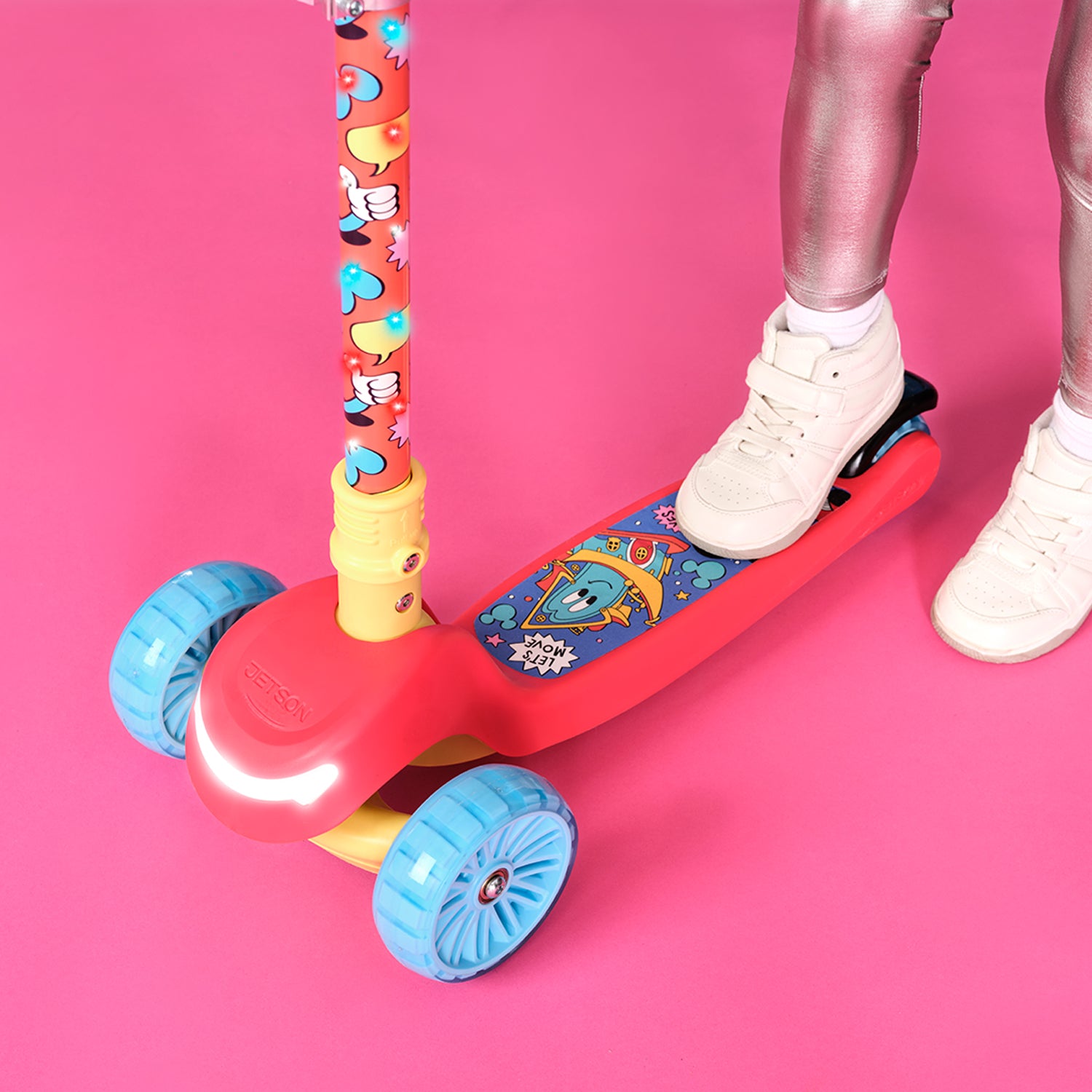 close up of a kid's foot on the deck of the mickey mouse kick scooter