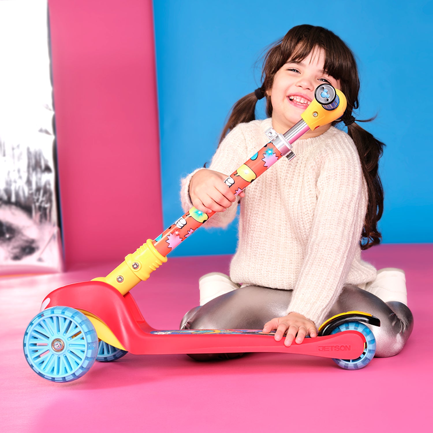 young girl folding mickey mouse kick scooter in half