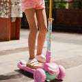 young kid riding princess kick scooter