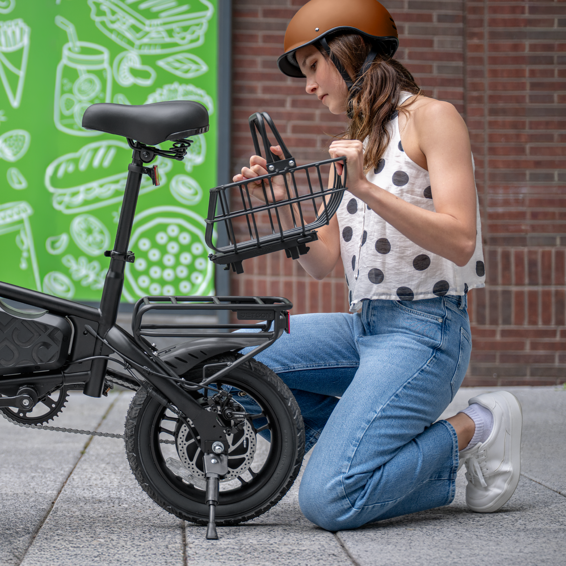 woman kneeling next to bike to attach metal basket
