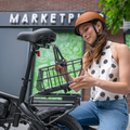 woman installing metal basket onto bike