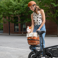 woman putting purse with flowers in rear metal basket