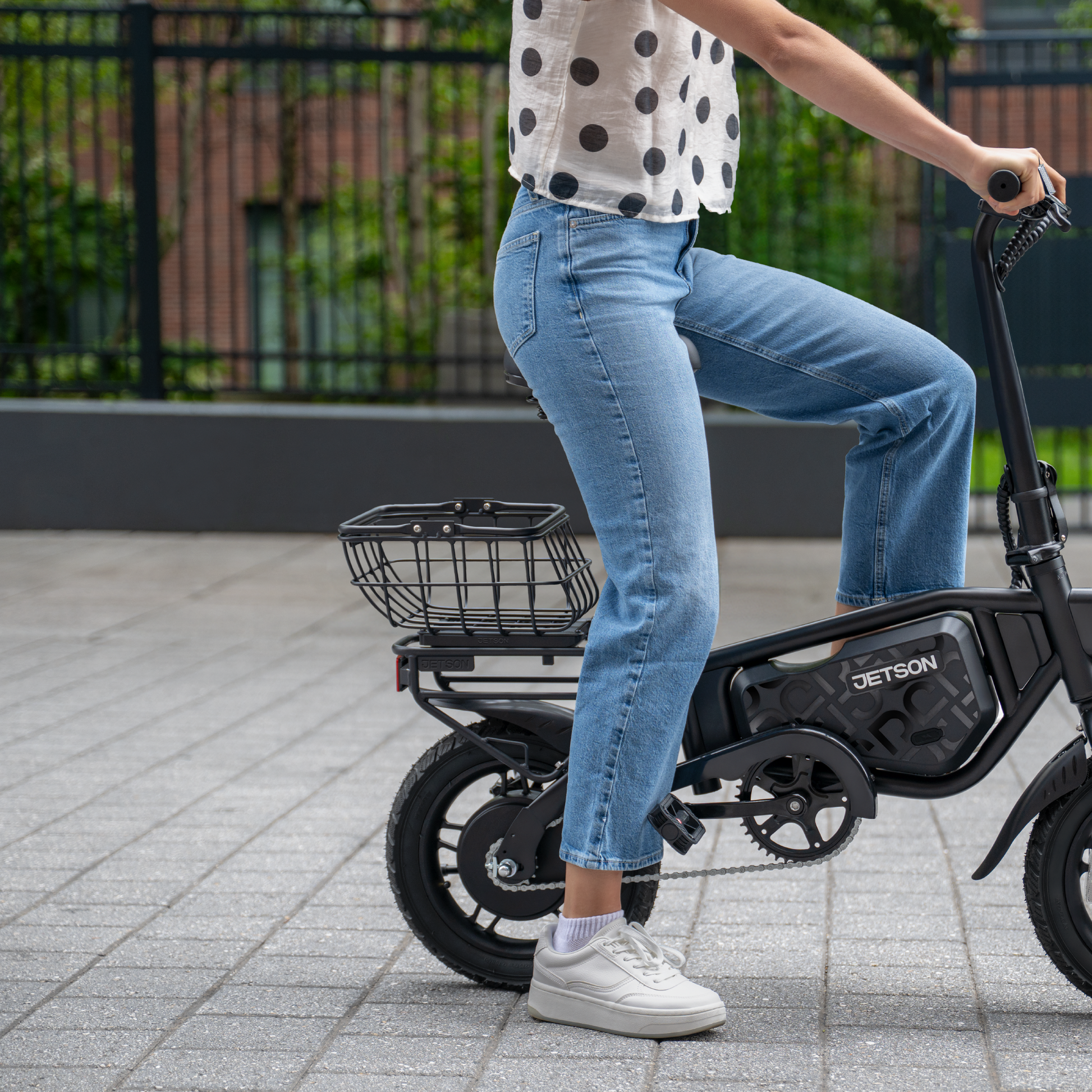 person sitting on an e-bike with an empty metal basket