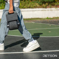 kid carrying a folded ring balance board by handle