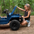 kid holding open the hood of the safara ride on