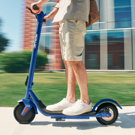 person riding shield scooter on the sidewalk