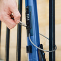 person using built in cable lock on their shield scooter