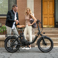 couple standing next to Venture electric bike