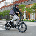 man riding Venture electric bike down the street