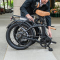 person folding Venture electric bike
