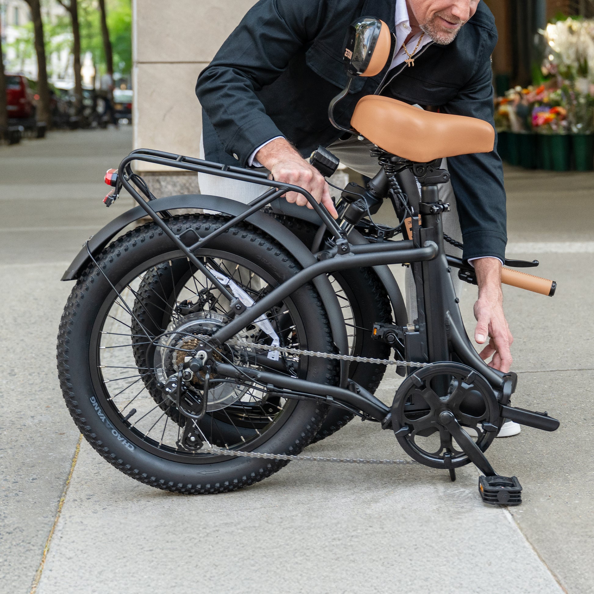 person folding Venture electric bike