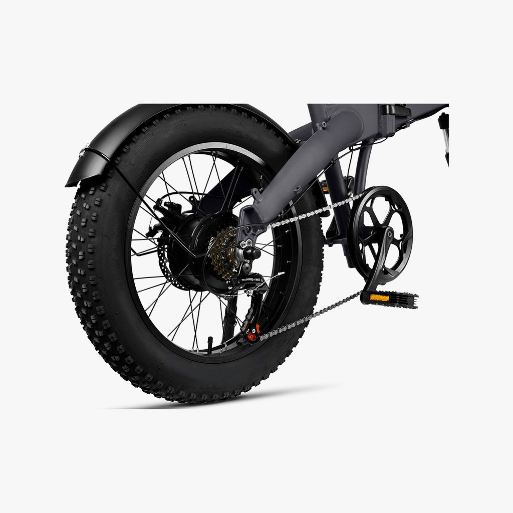 close up of the rear wheel, chain, and pedal on the warren