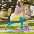 girl having fun pushing herself off to get momentum on her Disney kick scooter