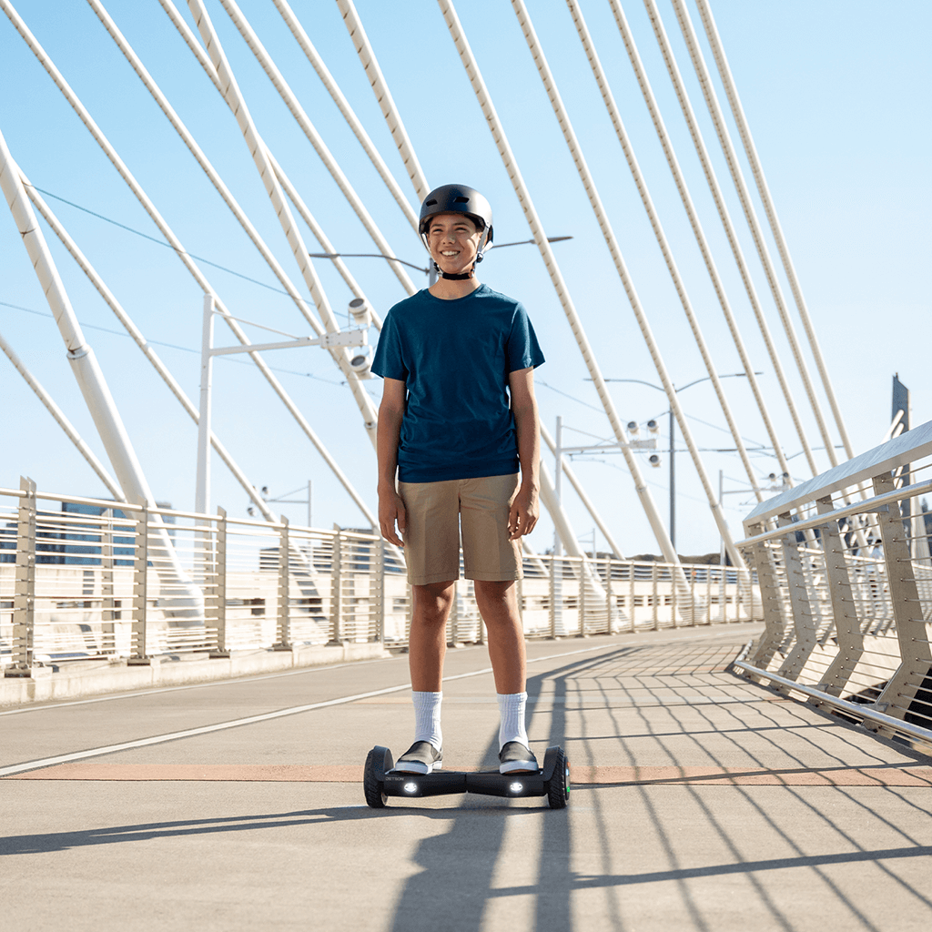 kid riding black spin hoverboard