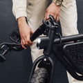 person folding the atlas electric bike handlebar down