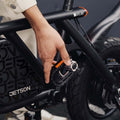 person folding the pedals in on the atlas electric bike