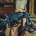 person carrying a folded Bolt Pro by the carrying handle