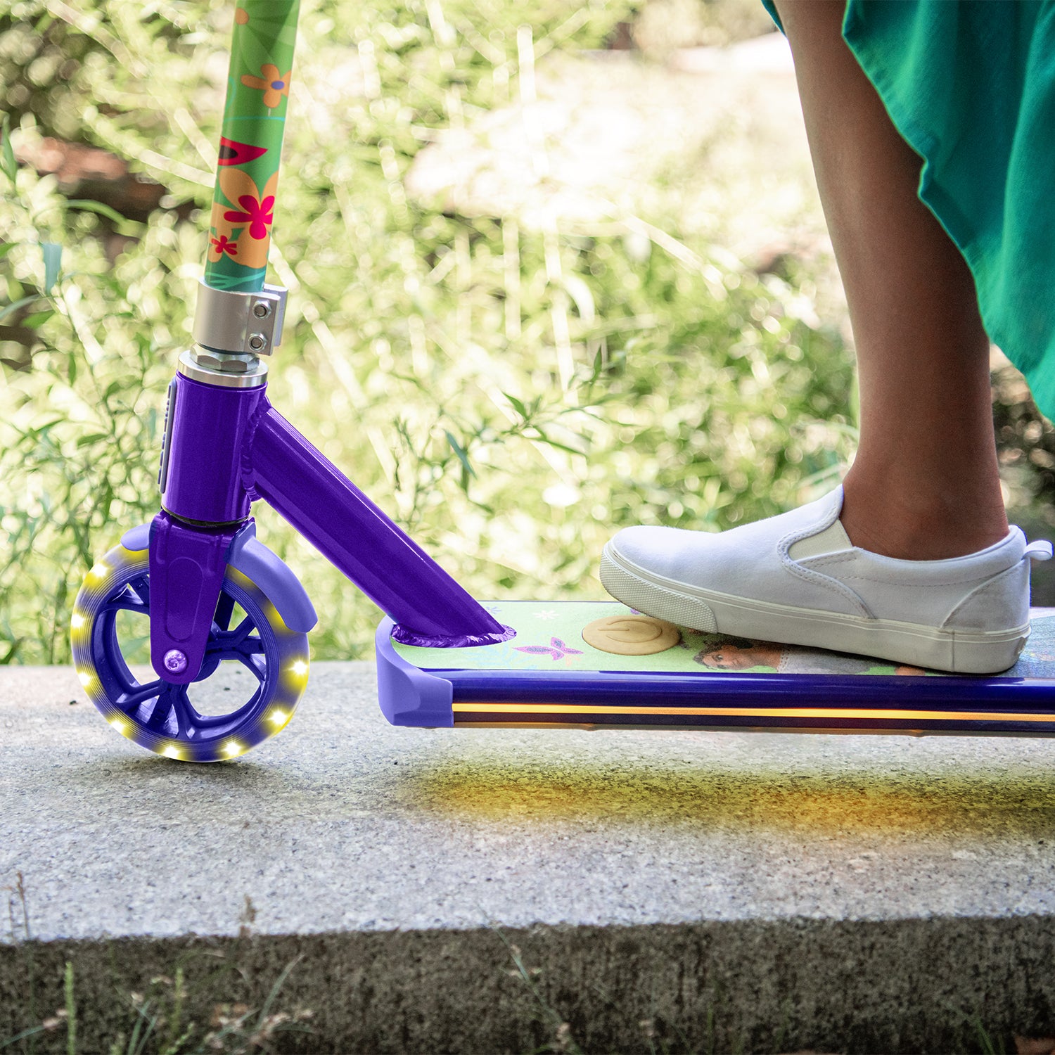close up of the light up wheel and deck on the disney encanto electric scooter