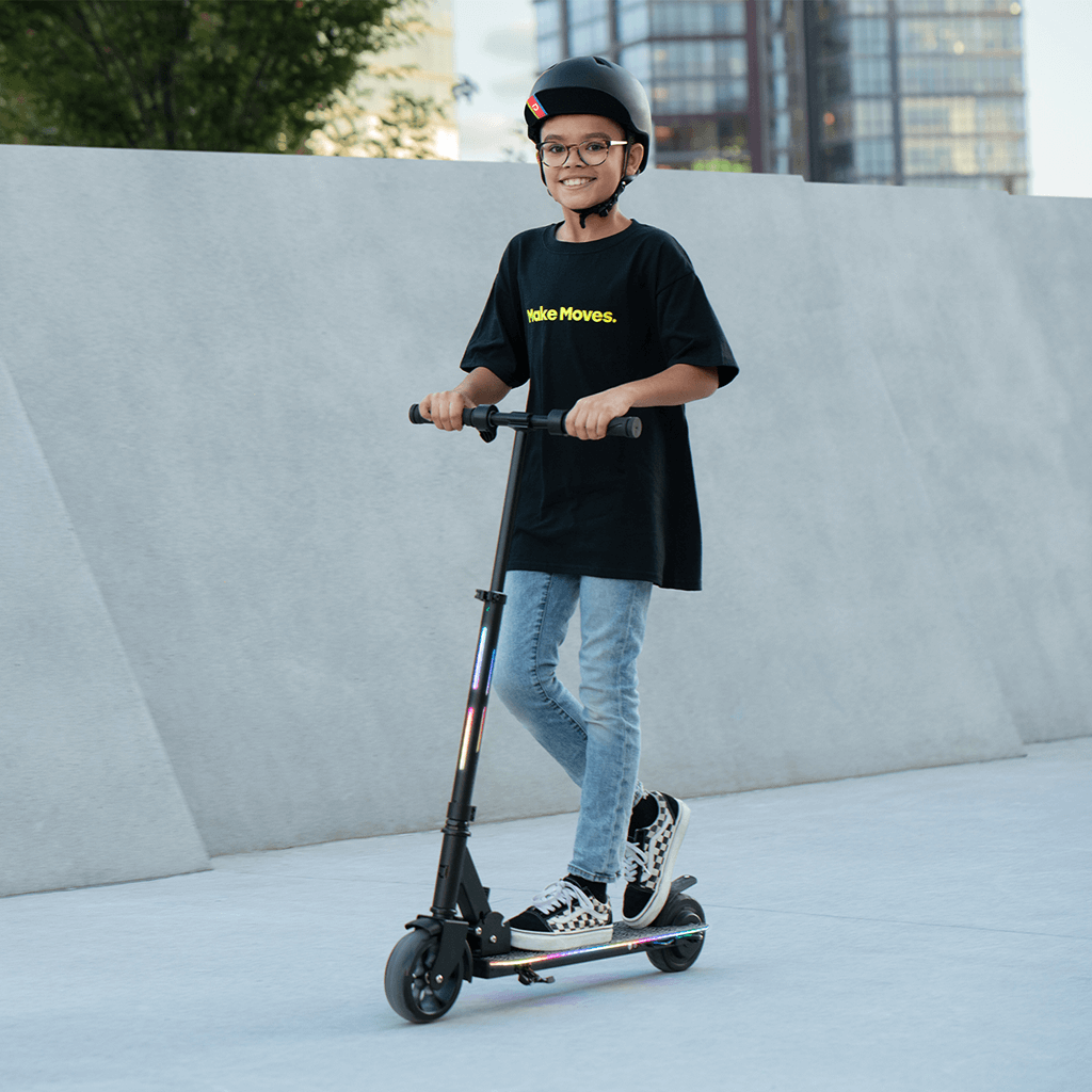 young person riding e- scooter while smiling