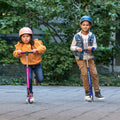 two kids riding pink and blue helio x kick scooters