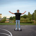 person riding gray impact hoverboard