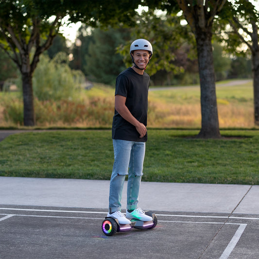 person riding gray impact hoverboard