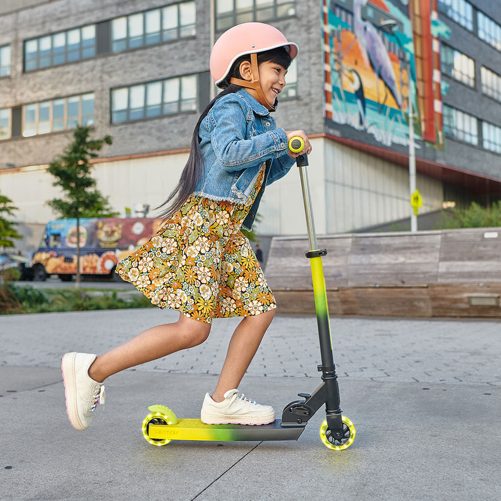 young kid riding electric yellow juno kick scooter