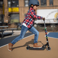 young kid riding black jupiter kick scooter