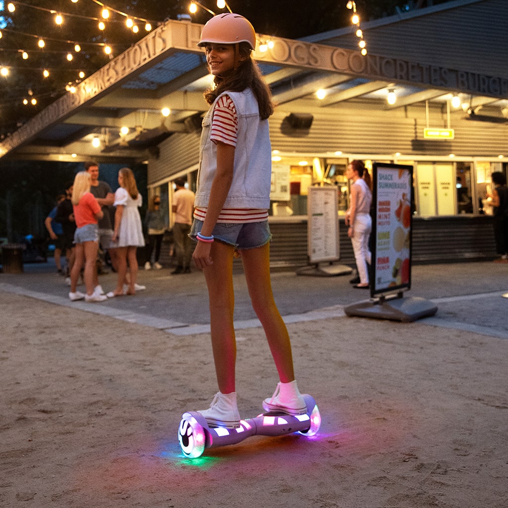 young girl in front of a burger stand riding the Litho X hoverboard