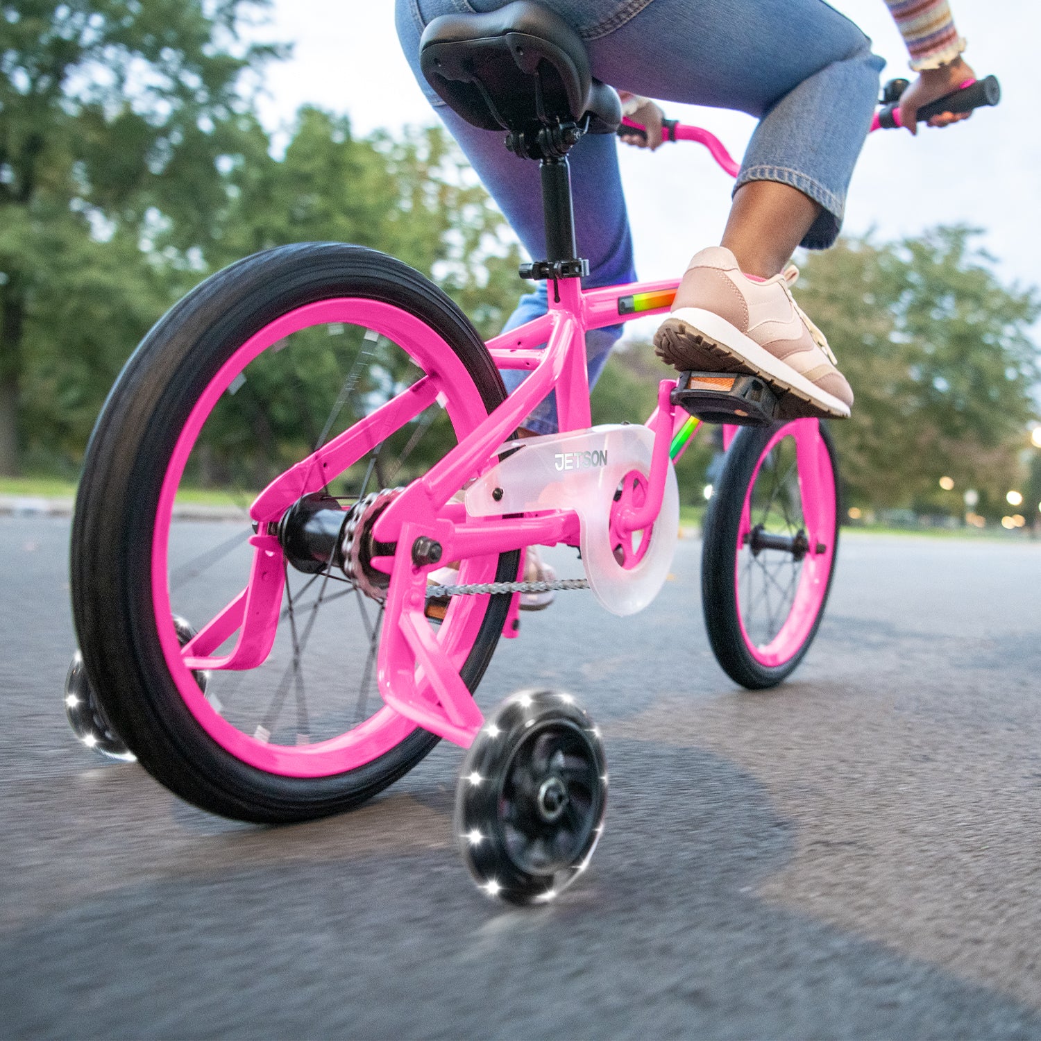 close up of rear wheel and light up training wheels on pink light rider 16